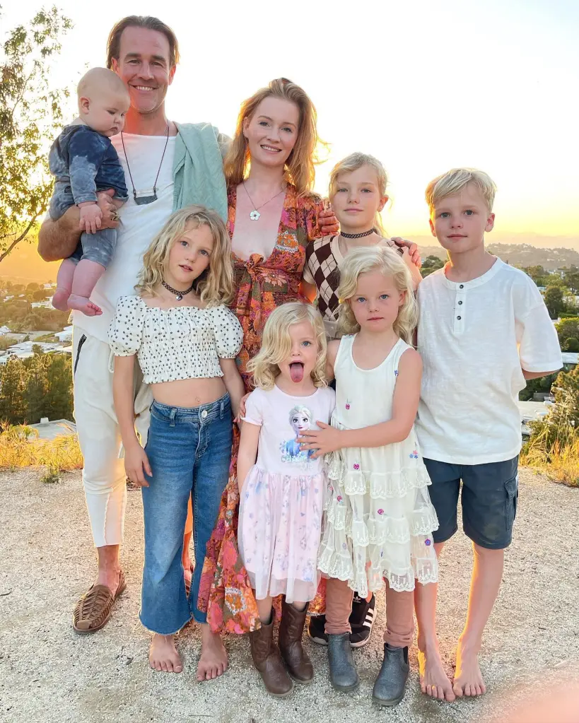 James Van Der Beek, his wife Kimberly, and their six children pose for a family photo outdoors at sunset.