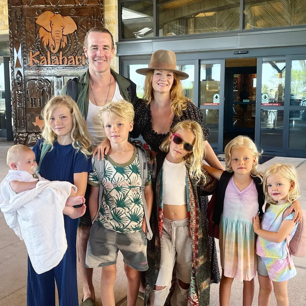James Van Der Beek, his wife Kimberly, and their six children posing in front of a Kalahari resort entrance.