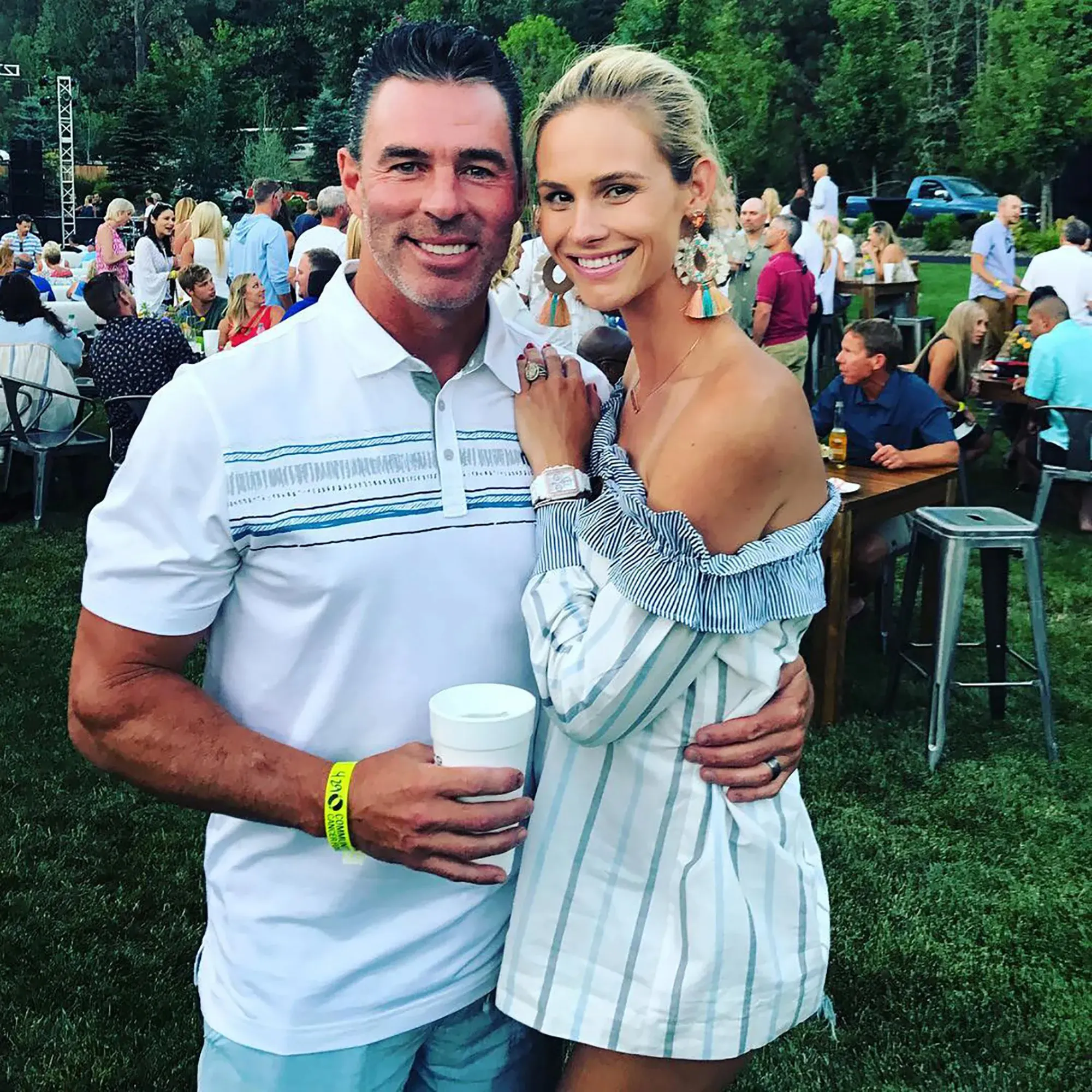 Meghan King and Jim Edmonds pose together at an outdoor event.