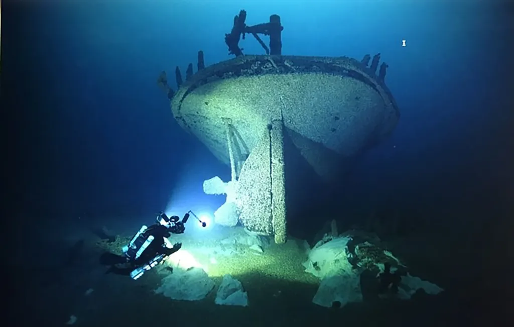 A diver exploring the stern of the shipwrecked Lac La Belle, missing a propeller.