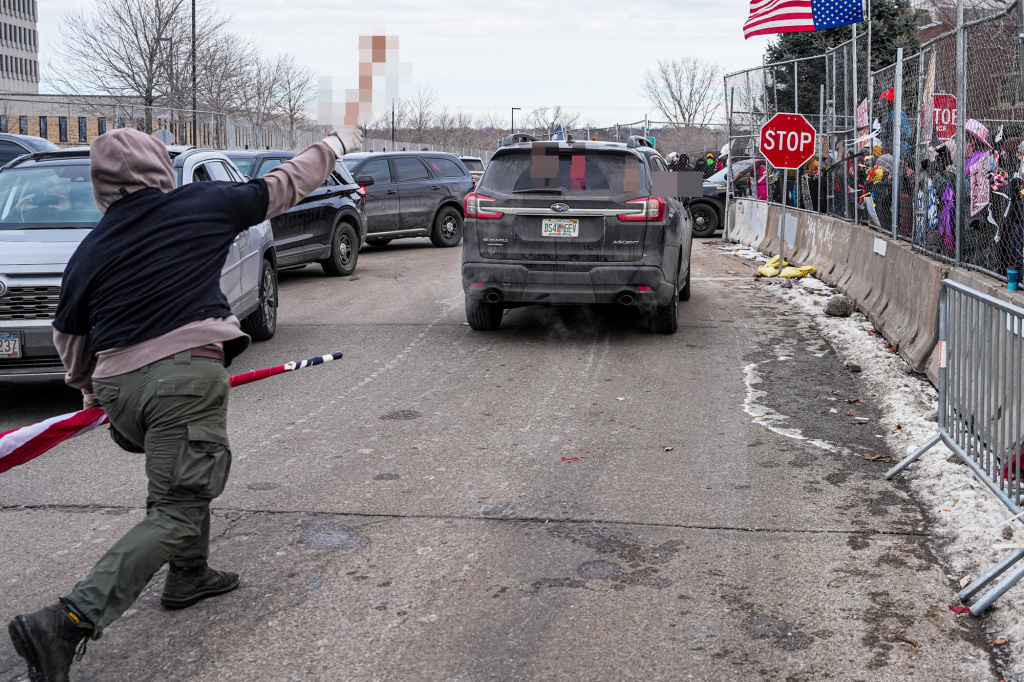 A protester throws sex toys at a car in Minneapolis during a protest on Feb. 7, 2026.