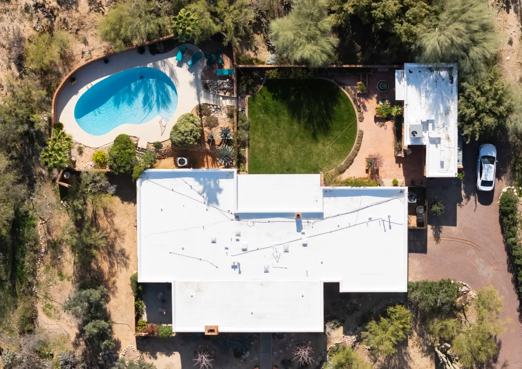 Aerial view of Nancy Guthrie's house in Tucson, Arizona, showing a swimming pool, backyard, and a white car in the driveway.