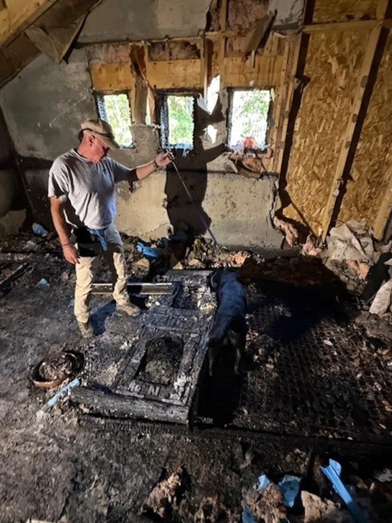 Nassau Fire Marshal K9 Leah sniffing out accelerants at a murder mystery case with her handler, investigator Matthew Kerin.