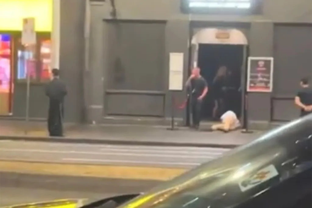As he falls to the ground, a security guard can be seen laughing and pointing at the victim.