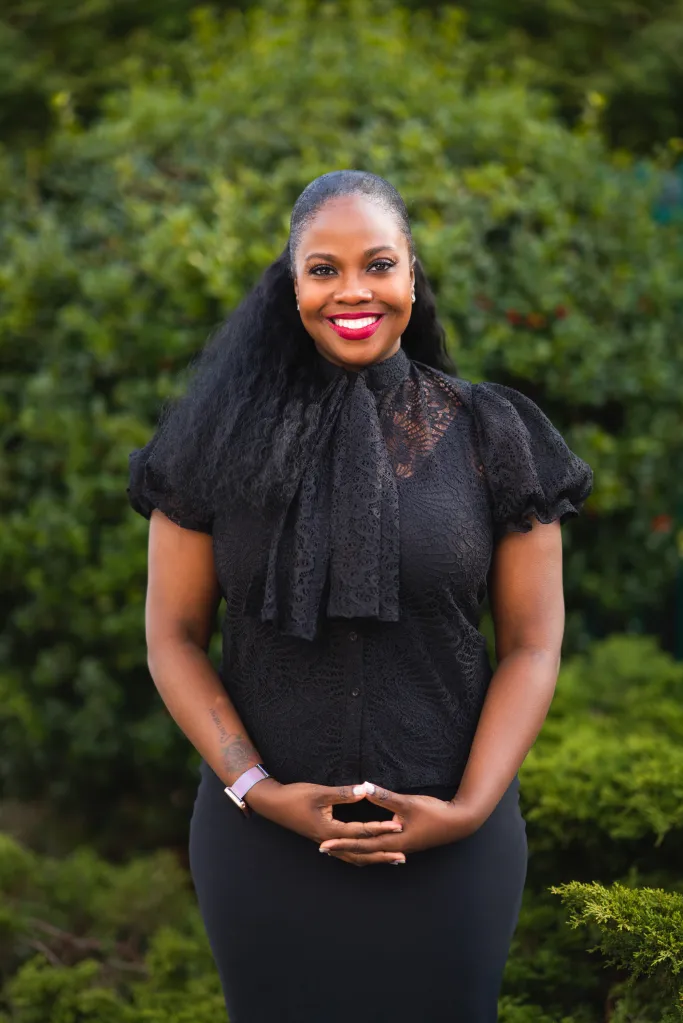 New York Assemblywoman Taylor Darling in a black lace top and black skirt.