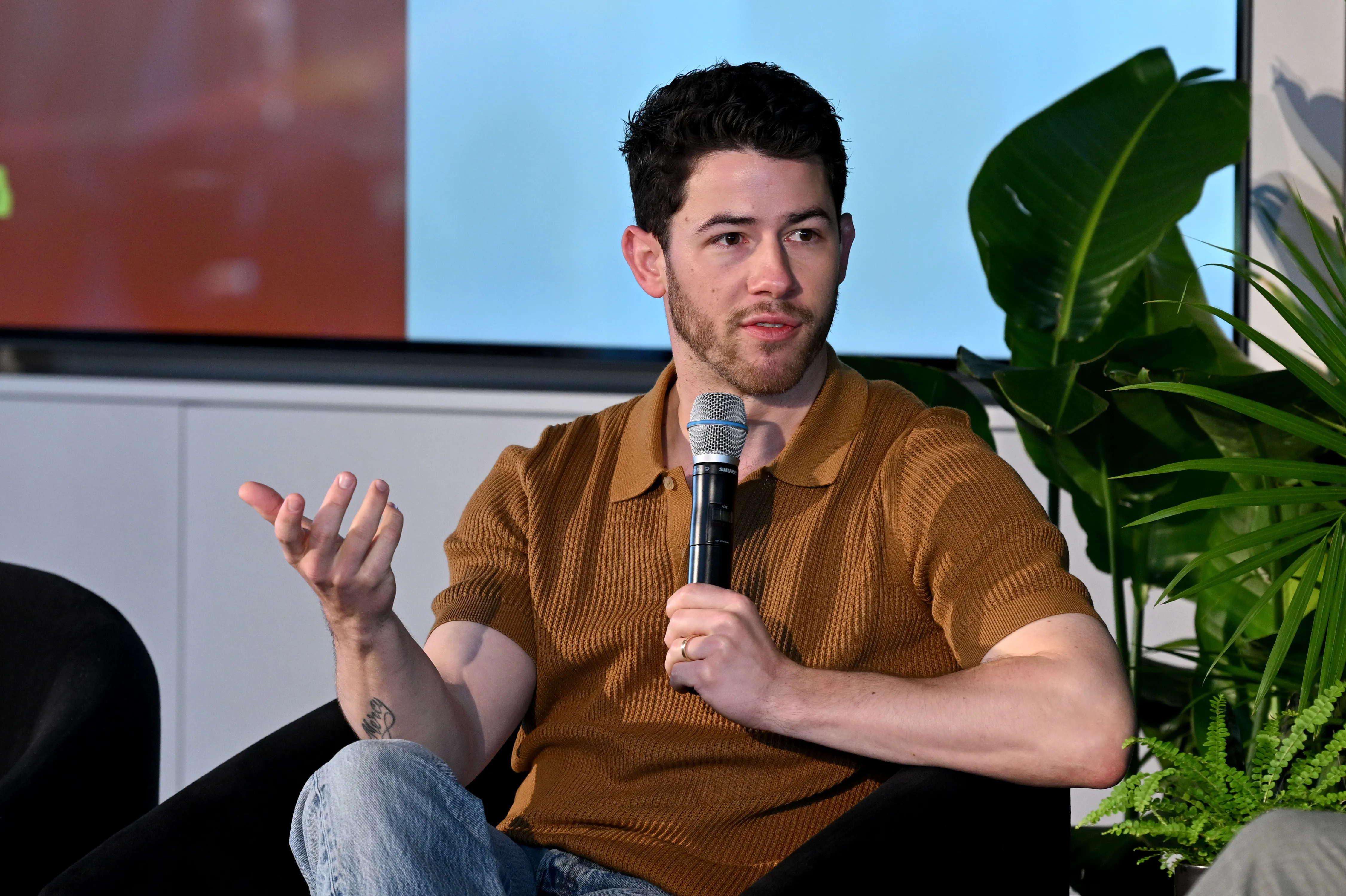 Nick Jonas speaking onstage at the Men's Health Lab.