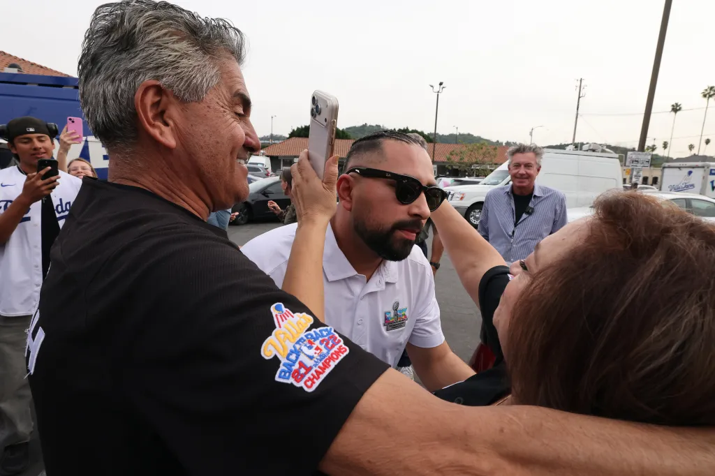 Owner Victor Villa hugs his parents as he returns to Villas Tacos in Los Angeles.