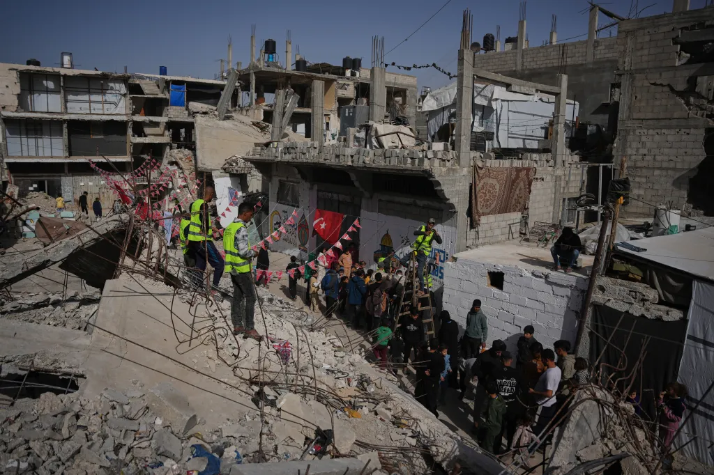 Palestinians hang decorations around destroyed buildings in Khan Younis, southern Gaza Strip, in preparation for Ramadan.