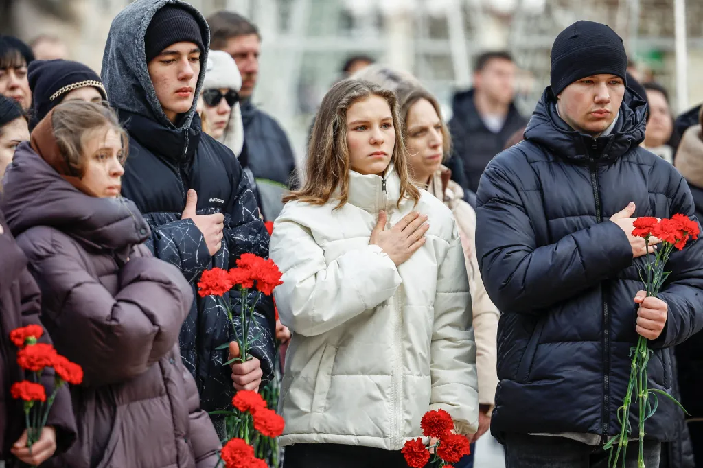 People gather during moment of silence to pay tribute to victims of the Russian aggression, on the day marking the fourth anniversary of the full-scale Russian invasion of Ukraine, amid Russia's attack on Ukraine, in the town of Irpin, Kyiv region, Ukraine February 24, 2026.