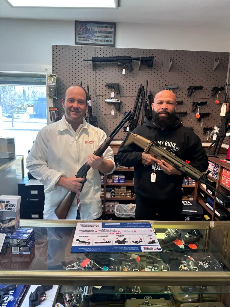 Lowell Pharmacy owner John Lykins displaying some of his store’s offerings with pal Stan Young, who helps out on busy Saturdays.