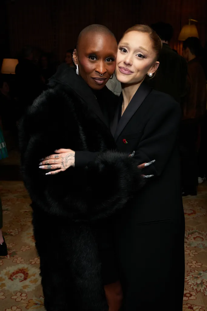 Cynthia Erivo and Ariana Grande embrace, smiling at a 