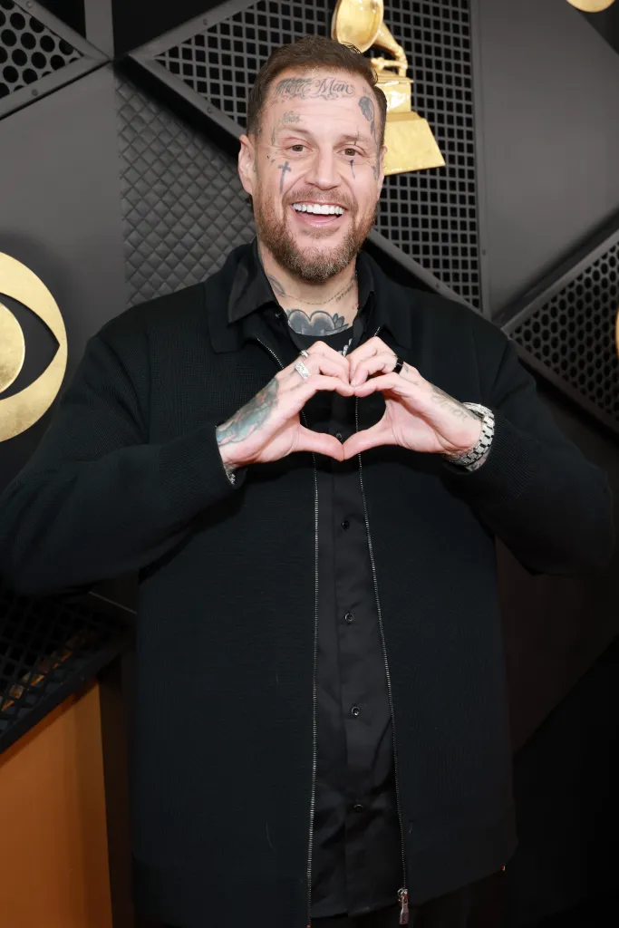 Jelly Roll making a heart shape with his hands at the 68th Grammy Awards.
