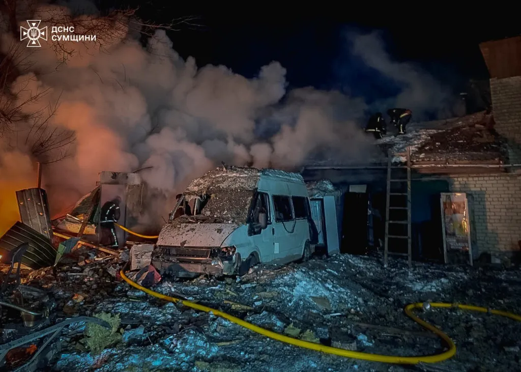 Emergency services personnel working to extinguish a fire in Kyiv following a Russian attack.