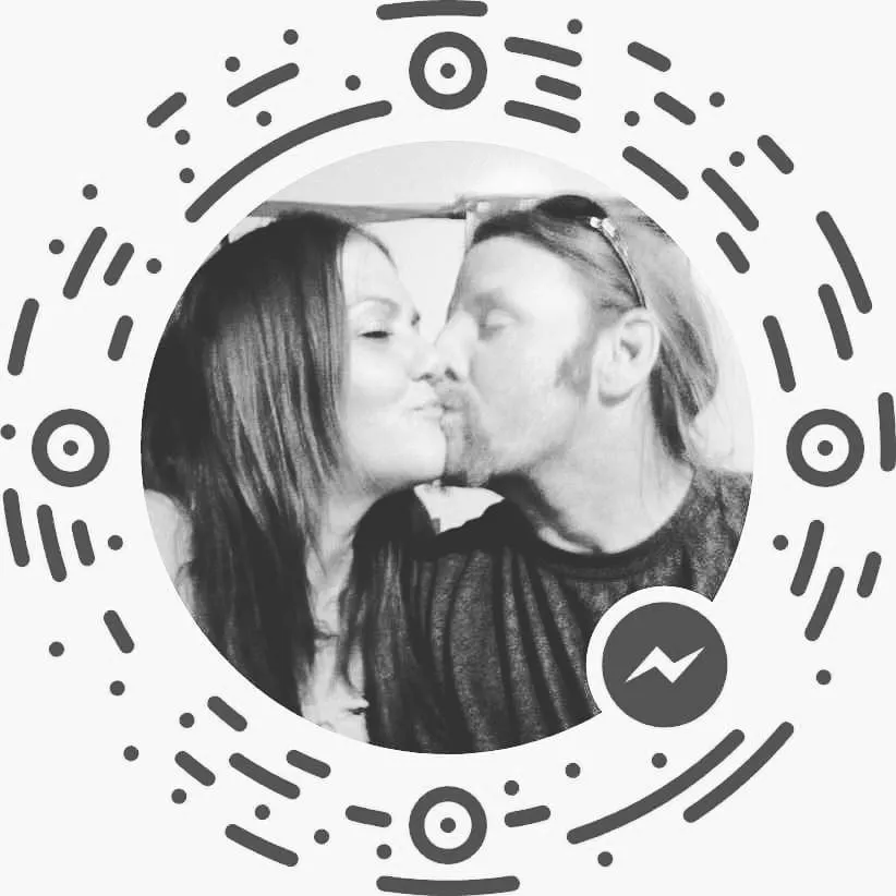 Black and white photo of Edward Jozwiak kissing a woman on the cheek.