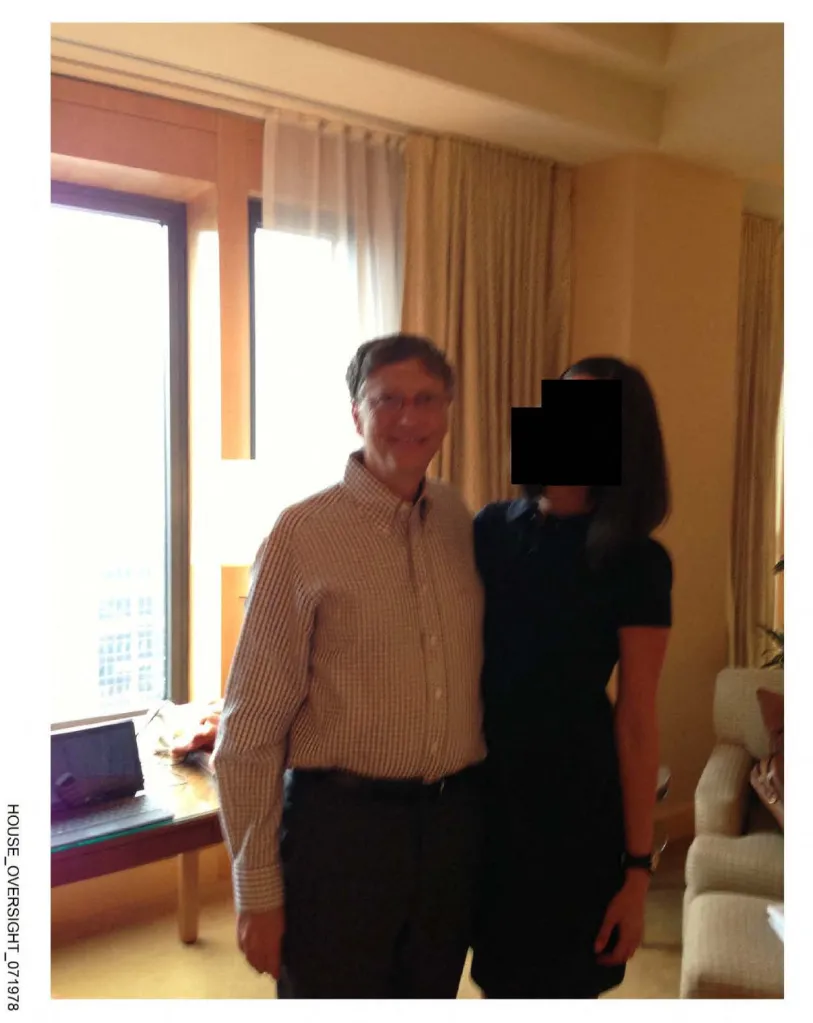 Bill Gates posing with a woman whose face has been redacted.