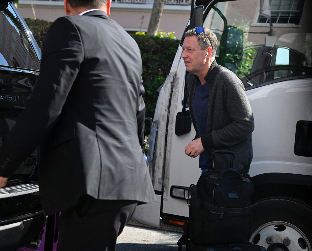 Michael Feldman, Savannah Guthrie's husband, getting out of a vehicle at an airport.