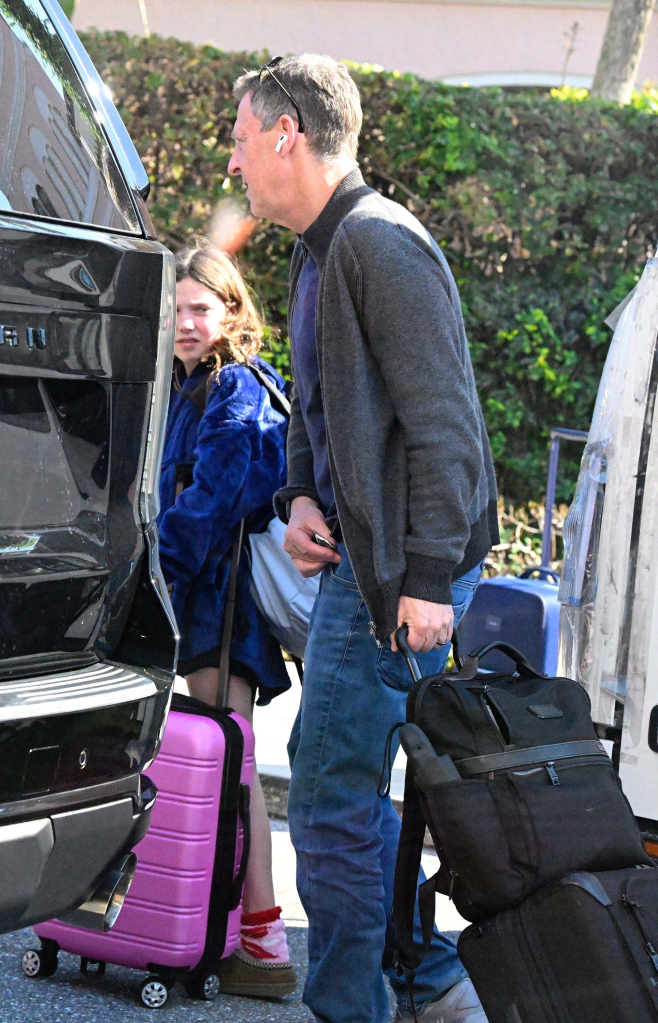 Michael Feldman and his daughter arriving at a Florida airport with luggage.