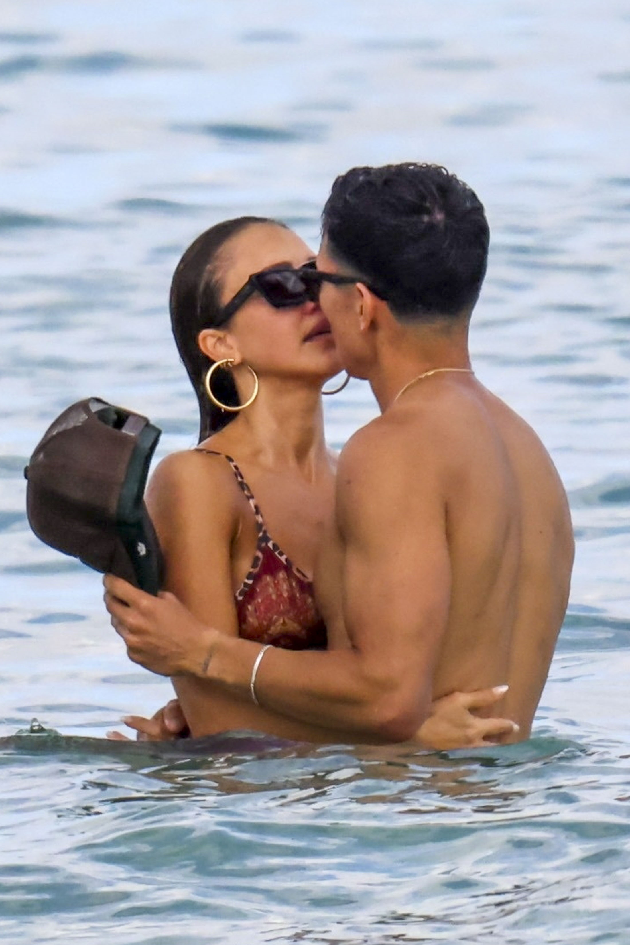 Jessica Alba and Danny Ramirez kissing in the ocean.