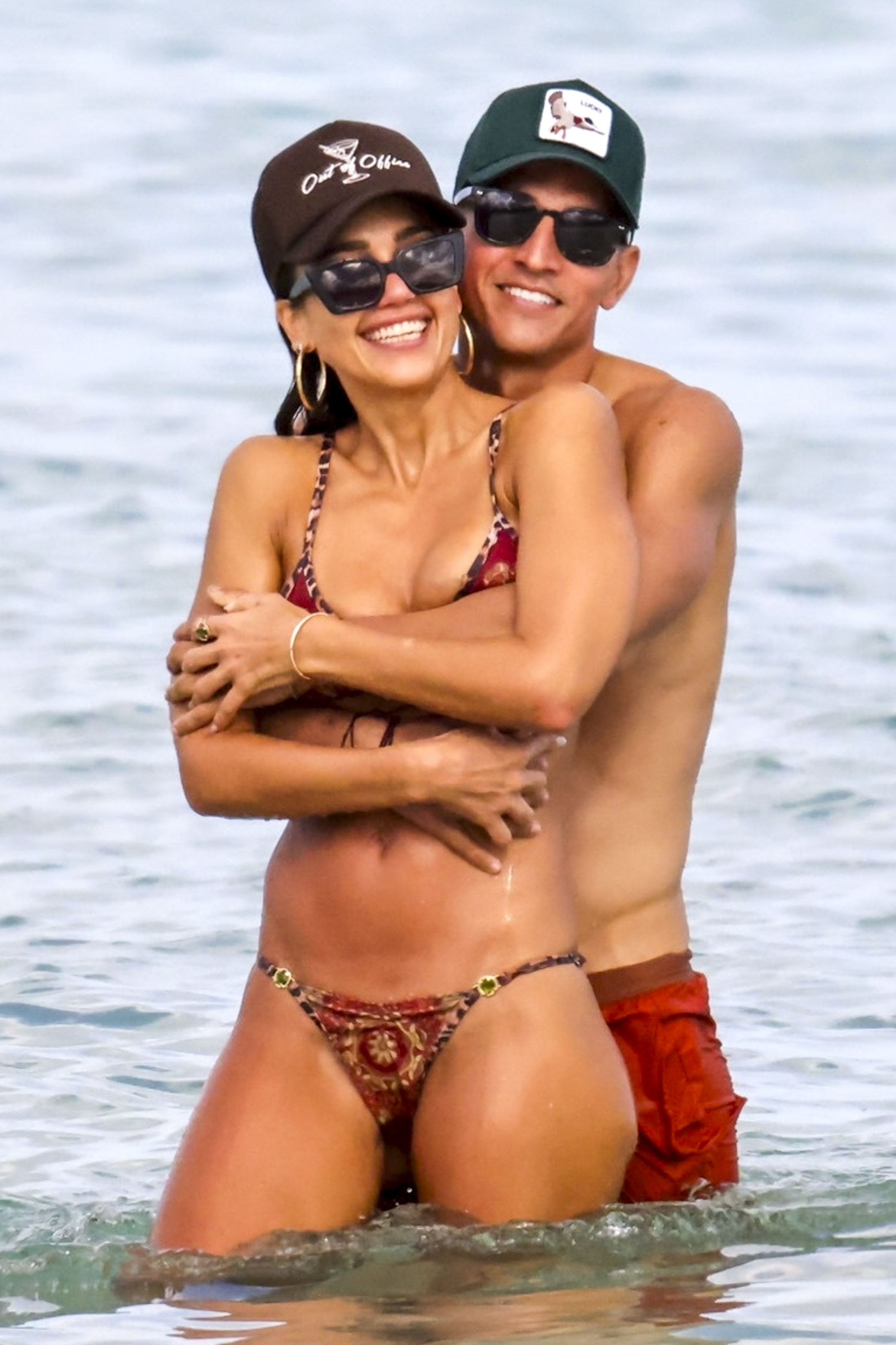Jessica Alba and Danny Ramirez embracing each other in the ocean.
