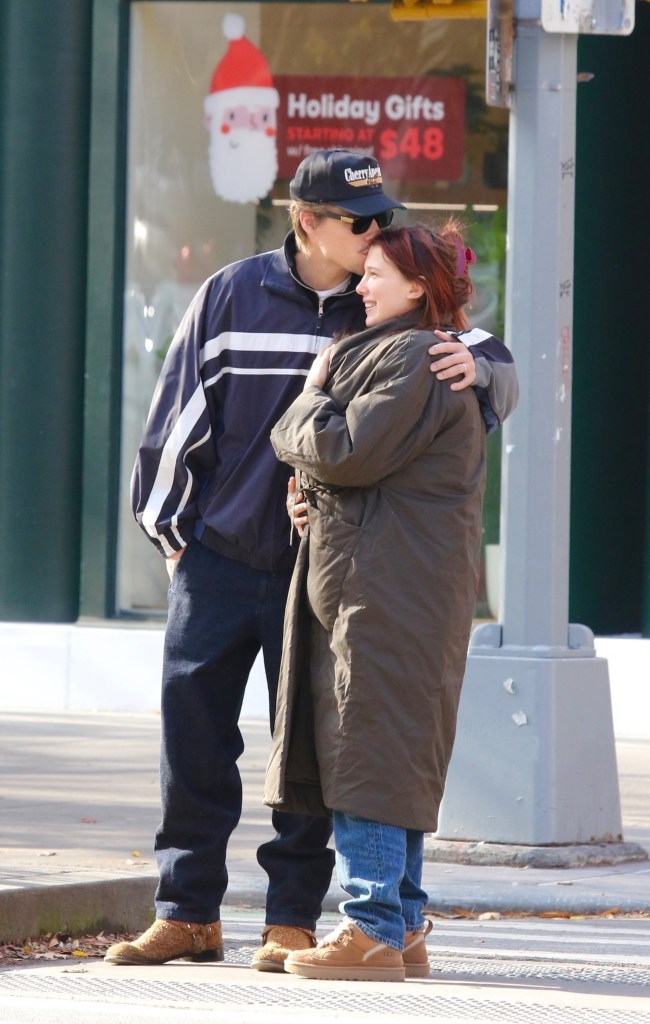 Jake Bongiovi kisses Millie Bobby Brown on the forehead as they share a tender moment.