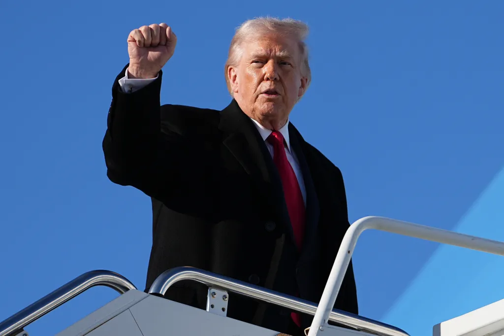 President Donald Trump gesturing as he boards Air Force One.