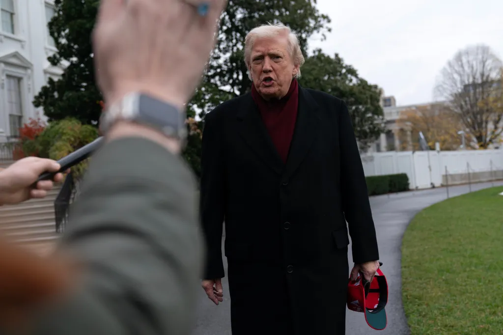 President Donald Trump talks to reporters outside the White House.