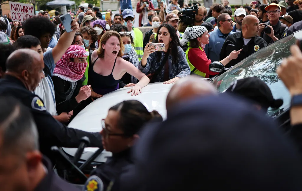 Pro-Palestine demonstrators arguing with public safety officers at the University of Southern California.