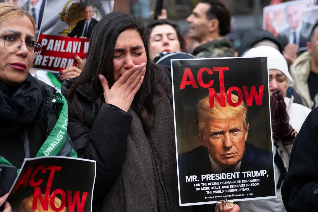 A protester calls on President Donald Trump to 