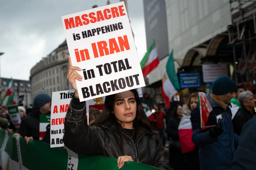 A protester holds a sign that reads 