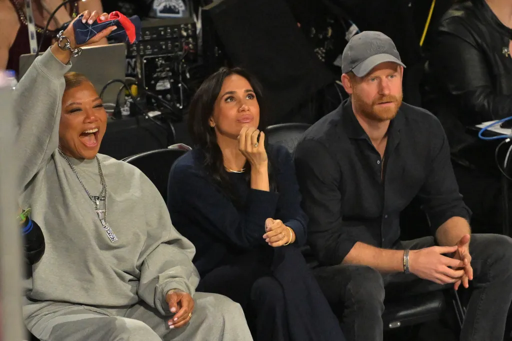 Queen Latifah, Megan Markle, and Prince Harry watch an NBA game.