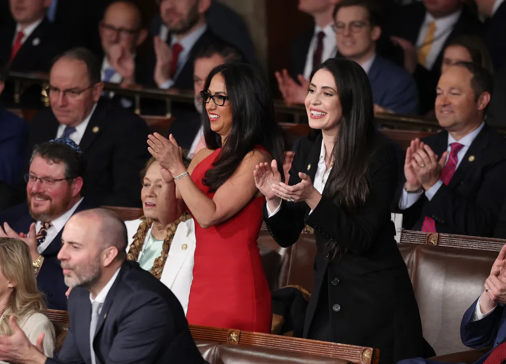 Representatives Lauren Boebert and Anna Paulina Luna applaud.