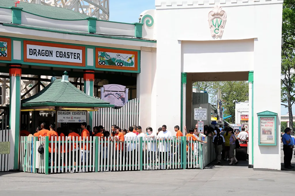 People waiting in line for the Dragon Coaster ride at Playland.