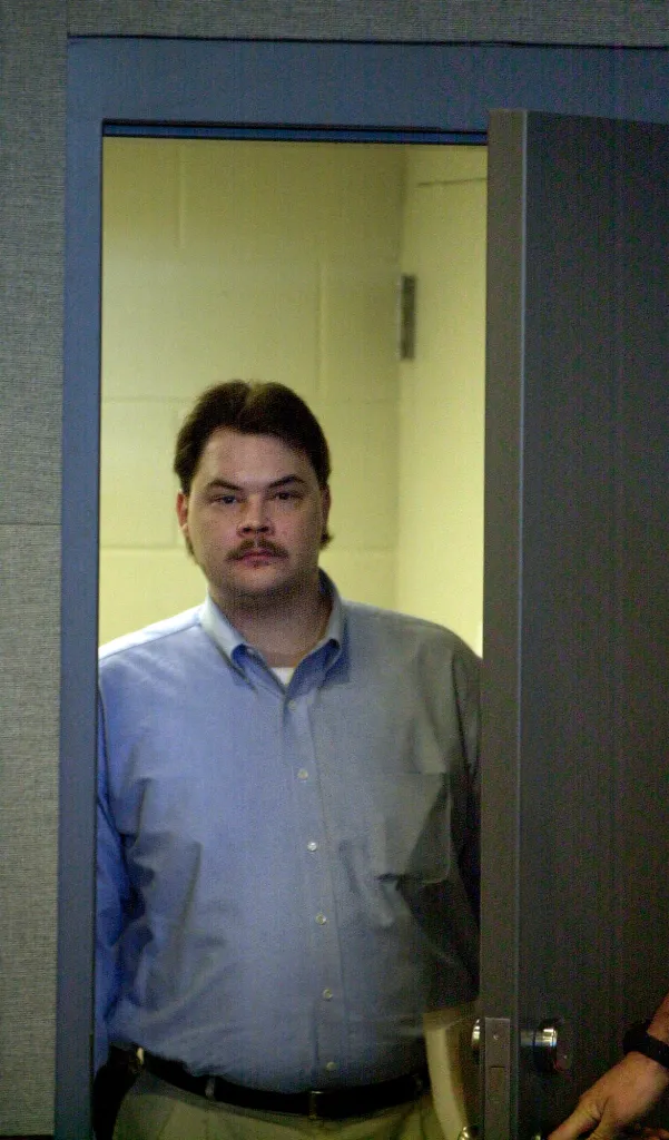 Robert Springsteen enters a courtroom during his murder trial.