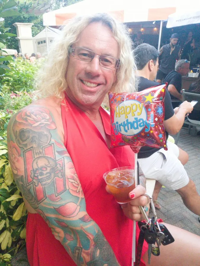 Roberta Esposito (also known as Robert Dorgan), holding a drink and a 