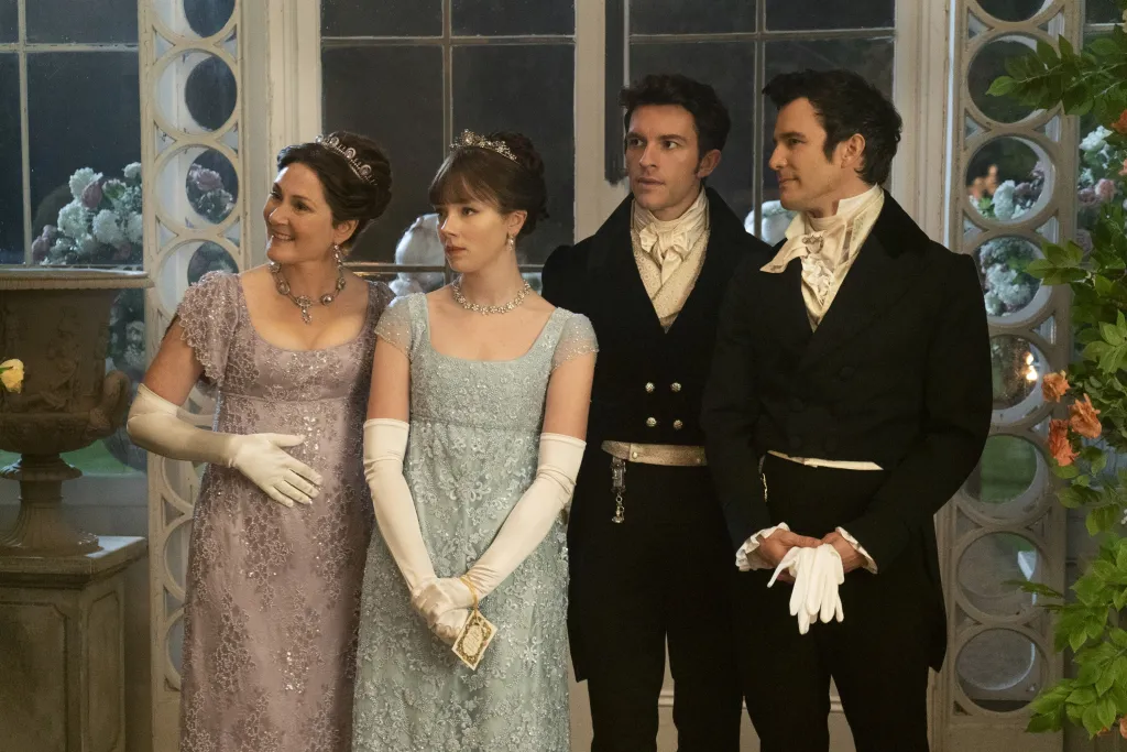 Ruth Gemmell, Claudia Jessie, Jonathan Bailey, and Luke Thompson in period clothing from the TV series Bridgerton.