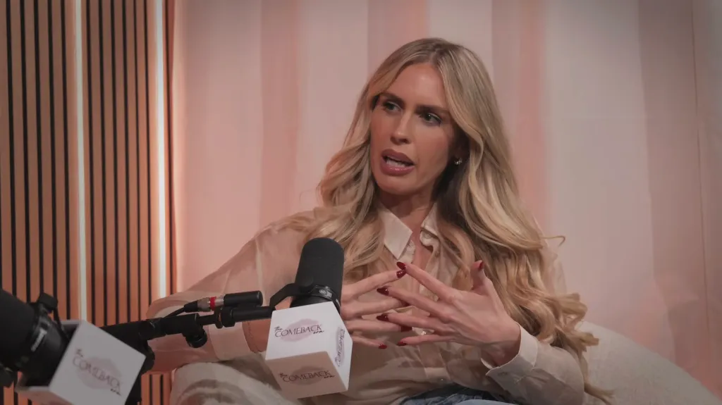 Ryan Lochte's estranged wife, Kayla Rae Reid, sitting in a studio next to a microphone, speaking during an interview.