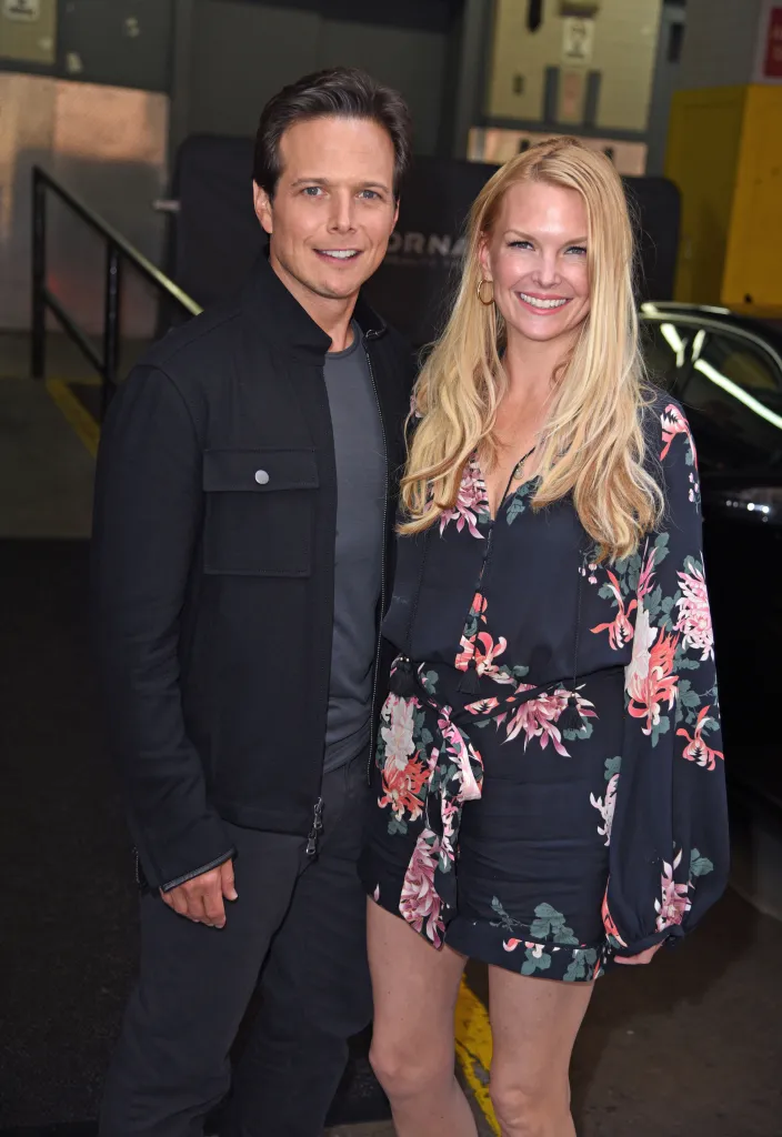 Scott Wolf and Kelley Limp smiling outdoors.