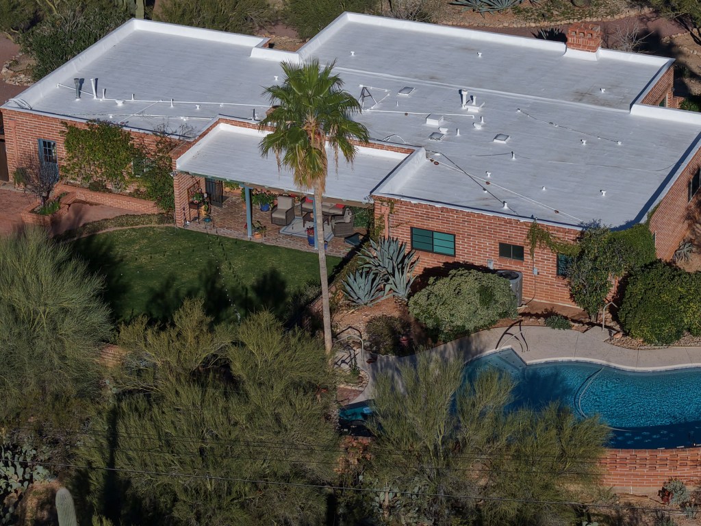 Aerial view of Nancy Guthrie's home in Tucson, Arizona, showing the brick house, backyard, and swimming pool.