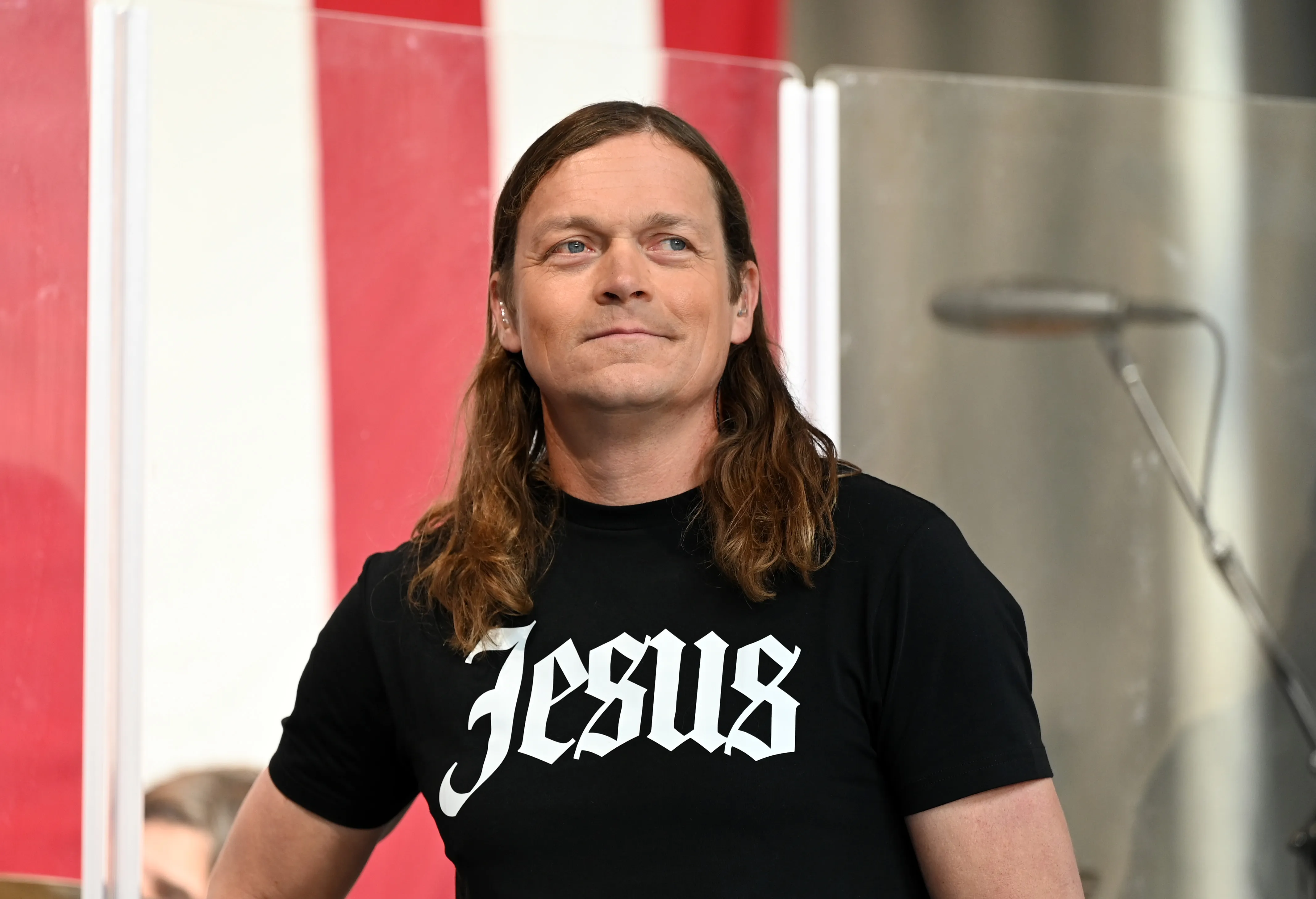 Singer Brad Arnold of 3 Doors Down performing at a concert.