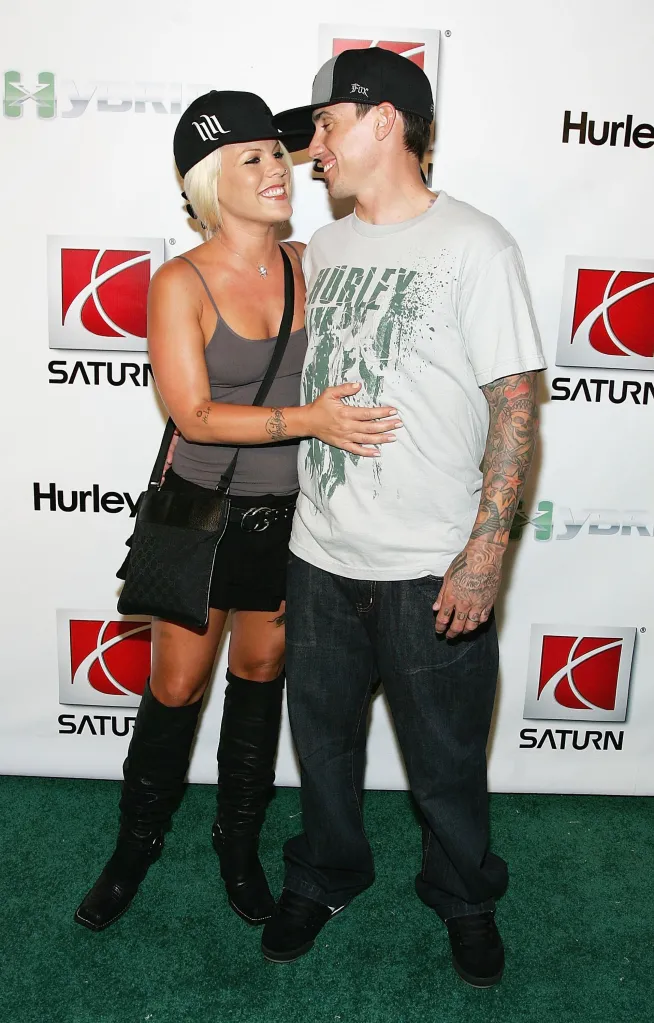 Singer Pink and husband Carey Hart pose for a photo at an event.