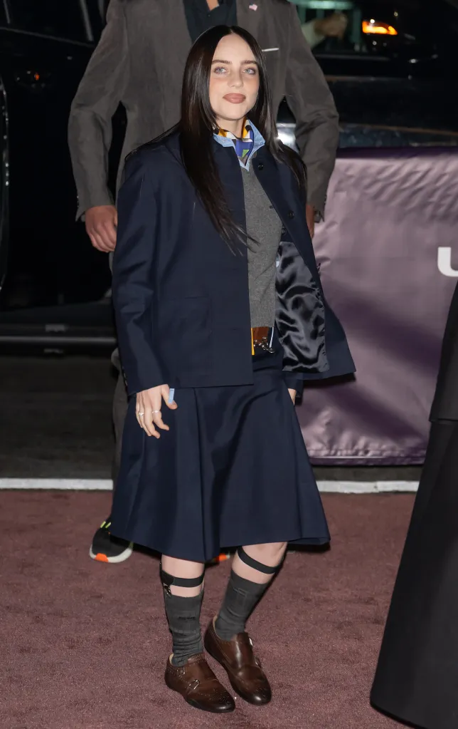 Billie Eilish posing on a red carpet.