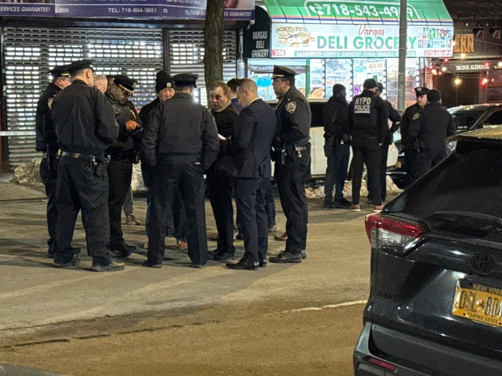 NYPD officers secure the scene after a teen was killed and two others wounded in Kingsbridge on Wednesday.