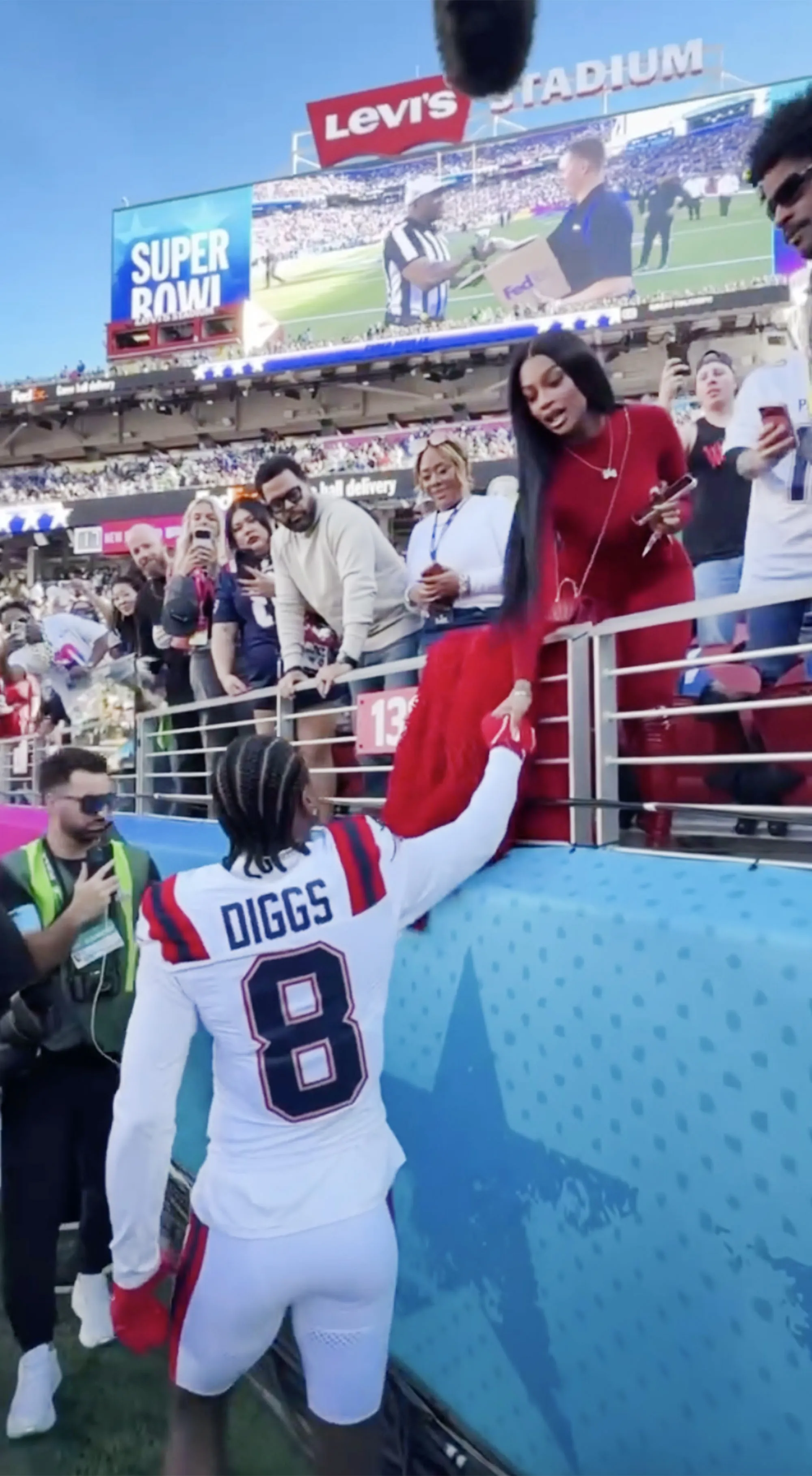 Stefon Diggs reaches to shake hands with Pree at Super Bowl LX.