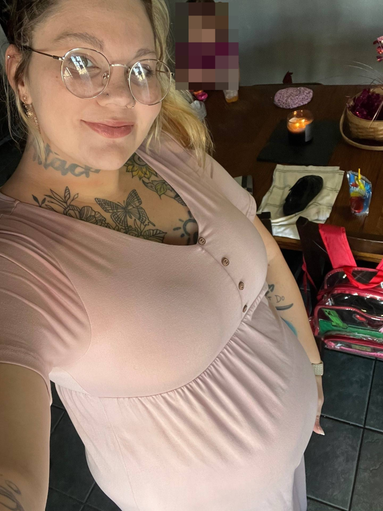 Kayla Elliot, a surrogate gestational carrier, is pregnant in a photo.