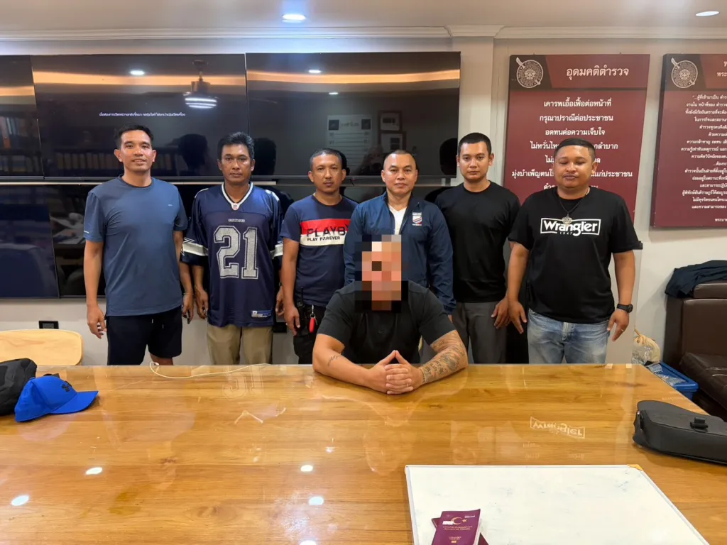 Pektas Tuguy Tayyar, a Swedish man, seated at a wooden table with his face blurred, surrounded by six unblurred men standing behind him.