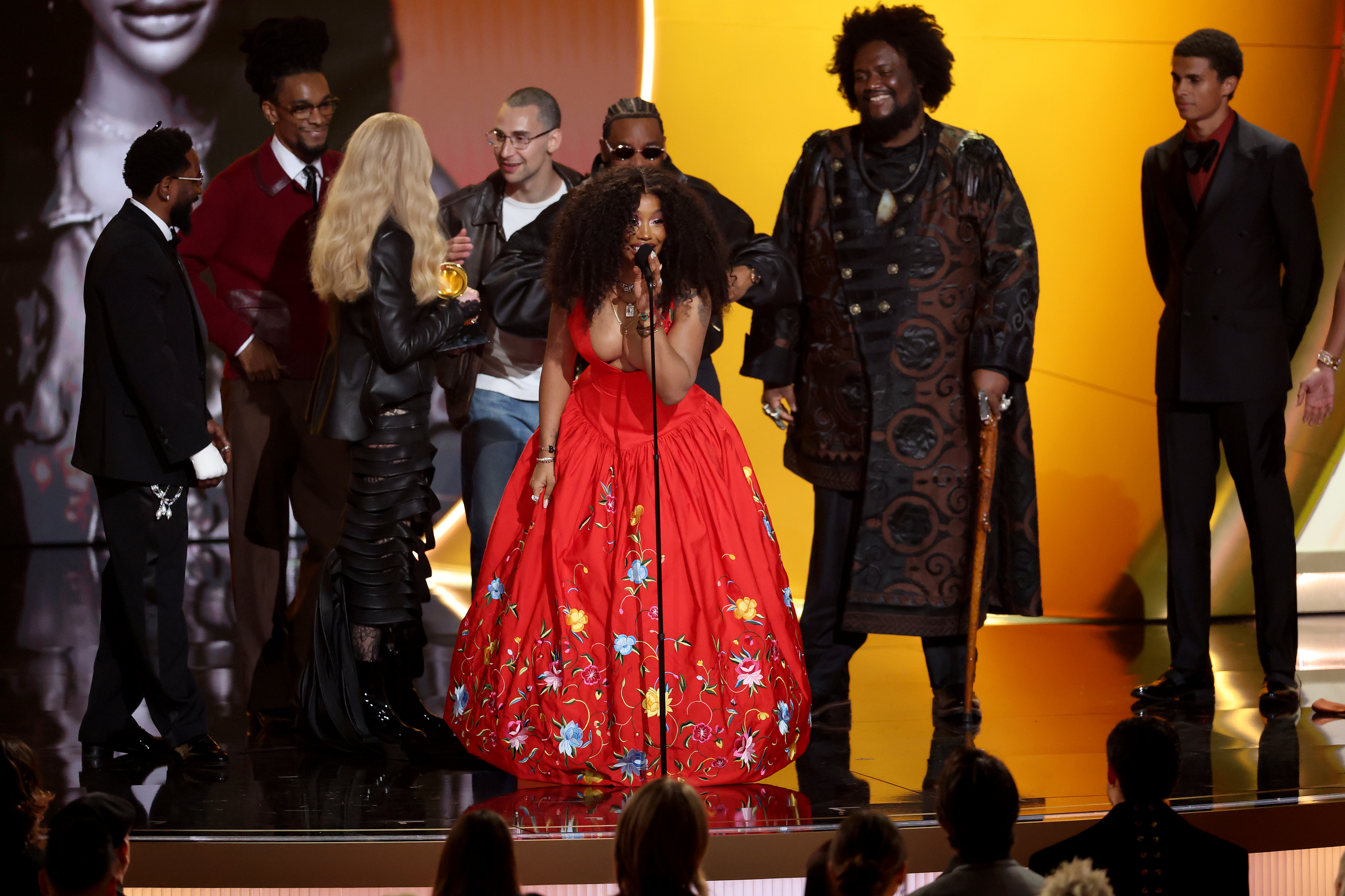 SZA (in the red dress) with with Kendrick Lamar, Ruchaun Akers, Jack Antonoff, Mark Spears aka Sounwave, and Kamasi Washington onstage at the Grammys