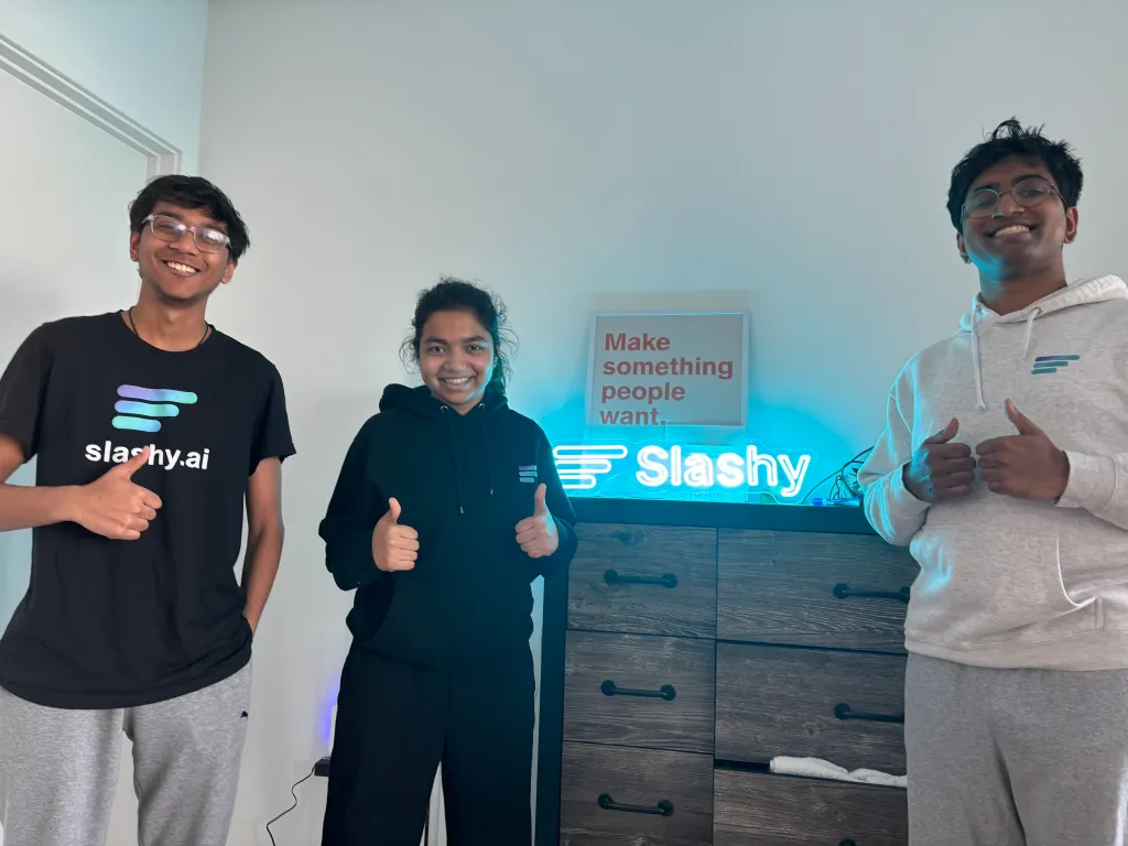Pranjali Awasthi and two co-founders in Slashy.ai shirts giving thumbs-up.