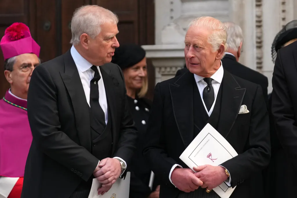 Prince Andrew and King Charles III talking outside Westminster Cathedral.