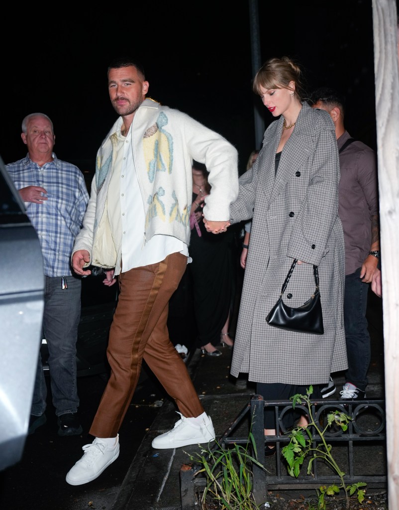 Taylor Swift and Travis Kelce holding hands while departing a party.