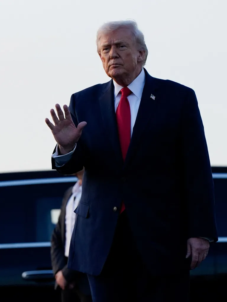 U.S. President Donald Trump waves as he disembarks Air Force One.